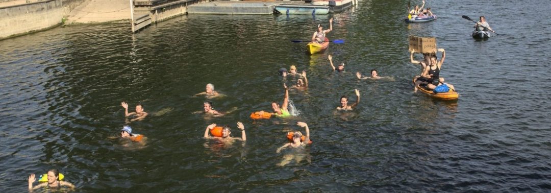 River swimmers waving to the camera